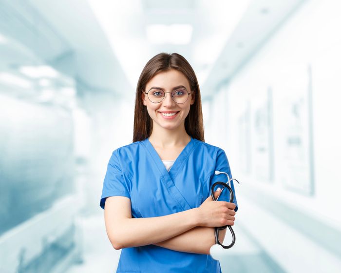A smiling nurse in a hospital hallway